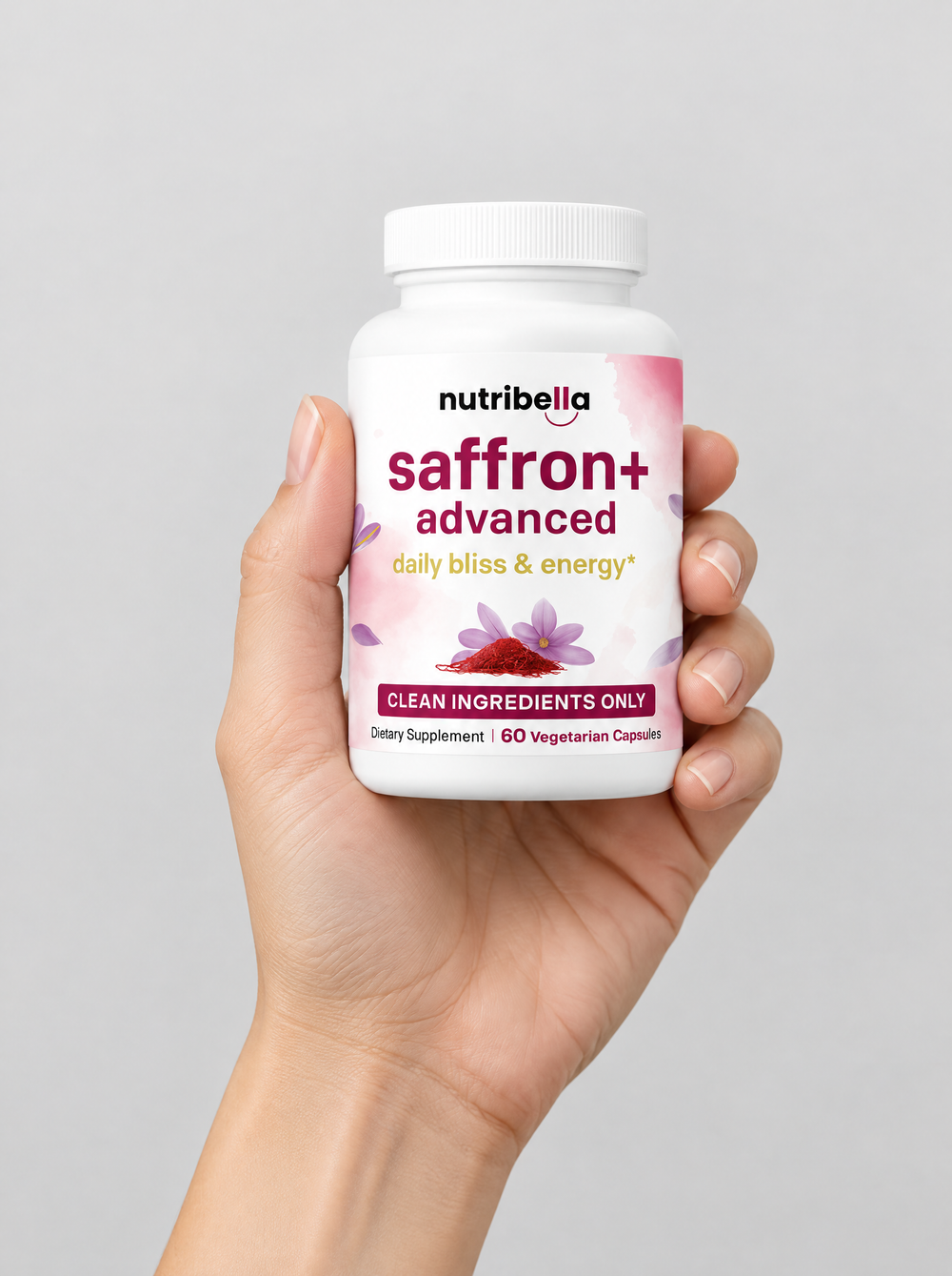 A hand holding a bottle of Nutribella Saffron+ Advanced