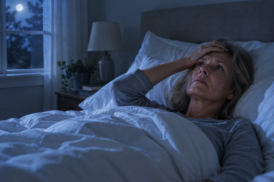 A woman in her fifties lying awake in bed in the middle of the night